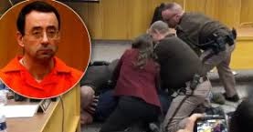A furious father of a sexual assault victim tried to attack Larry Nassar in...