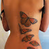 Brown flying tattoo on full back 
