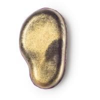 A large dark brown and purple slightly tear dropped/ear shaped soap with sparkly gold on the top on a bright background