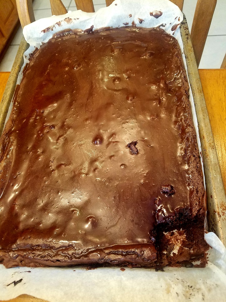 this is a baked cake with a piece missing to show how moist and decadent fudge it looks inside