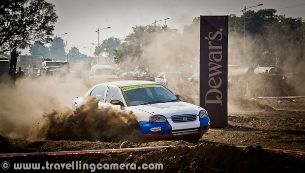 Last week, a motorsport event took place in Mohali (Near Chandigarh), which was organized by OYA Auto Cross and Motorcross. JK Tyre was one of the main sponsor of this event and it continued for three days. During final day I also visited the ground to bring this PHOTO JOURNEY for you. Let's check it out...Cars were literally flying on this ground and whole region was full of dust only. At times it was difficult to see these moving cars. It was hard to imagine that we were standing on a ground which is not in states like Rajasthan. The only word was coming to my mind at that point of time - Dust-Storm, like the one happens in Rajasthan; 'Desert Storm'... Let's check out more photographs from this series of Dust-Storm in Chandigarh...Different types of Cars and Bikes participated in this event, but cars competitions were mainly compelling us to rename it as 'Dust Storm'. Only two cars at a time were enough to cover sky with dust.I am not sure what this 'Dewars' was, but various pillars were planted on this ground. These should be some brands who supported this motorsport event. Barista was also there to serve snacks and drinks, but not sure if they were sponsors or not.Different cars by Honda, Maruti, Mitsubishi & Toyota participated in this event. At times, it was hard to believe that some specific cars can fly like this... One of the rider was very well controlling a white Swift, and it was competing with a 4 by 4 Jypsy...These cars were making the ground-dust to fly in air and at times, they used to cover themselves by dust storms. Specifically, there was huge dust on taking any turn.A colorful Maruti Car going down into a tunnel which was created artificially on this ground for Motorcross competitions during 3rd OYA sports-event.Passion of all these riders was commendable and it was hard to imagine that human beings were driving these super-machines.'Dust Storm' is something coined on run-time and not related to this event.I tried to check about this event on FMSCI website but couldn't find any details. Website of OYA was not much helpful for me to get information as non-motorsport person. Anyway, please have a loo at following link to know more about the organization which organized this event in Mohali - http://oyamohali.comWhole ground was surrounded by lot of people who wanted to see these races, but unfortunately the dust was biggest enemy. After one lap of car racing, there was nothing visible on ground. So everyone was more excited about bike racing, which had more participants at one point of time and things were visible as least.Motrosports in India is one of the increasing passion among people in cities like chadigarh. Now India is also getting some powerful machines, which was not that easy few years back. But still lot of folks can't afford these powerful machines without sponsorship and in such competitions, it's not easy thing to compete with imported machines with our usual bikes.Another shot where another car is contributing to Dust Storm on this ground in Mohali, Punjab, INDIA...After lot of dust in above photographs, I also thought of sharing some bike photographs to show another side of the PHOTO JOURNEY...It seems that bikers in such competitions also use their legs as supporting equipment while turning these machines on extremely high speed.With this, let me finish this Photo Journey of Dust Storm in Chandigarh (Mohali, Punjab)