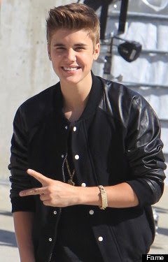Justin Beiber, peace sign, black leather coat, haircut, smiling, braclet, sunny, vanilla ice