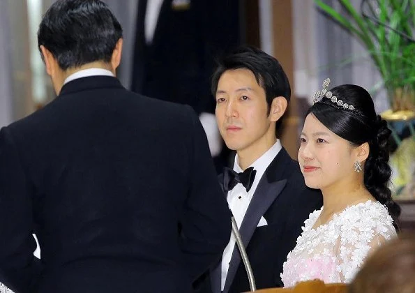 Crown Prince Naruhito and Crown Princess Masako at weeding banquet. Princess Ayako wore a pink silk dress designed by designer Norio Suzuki