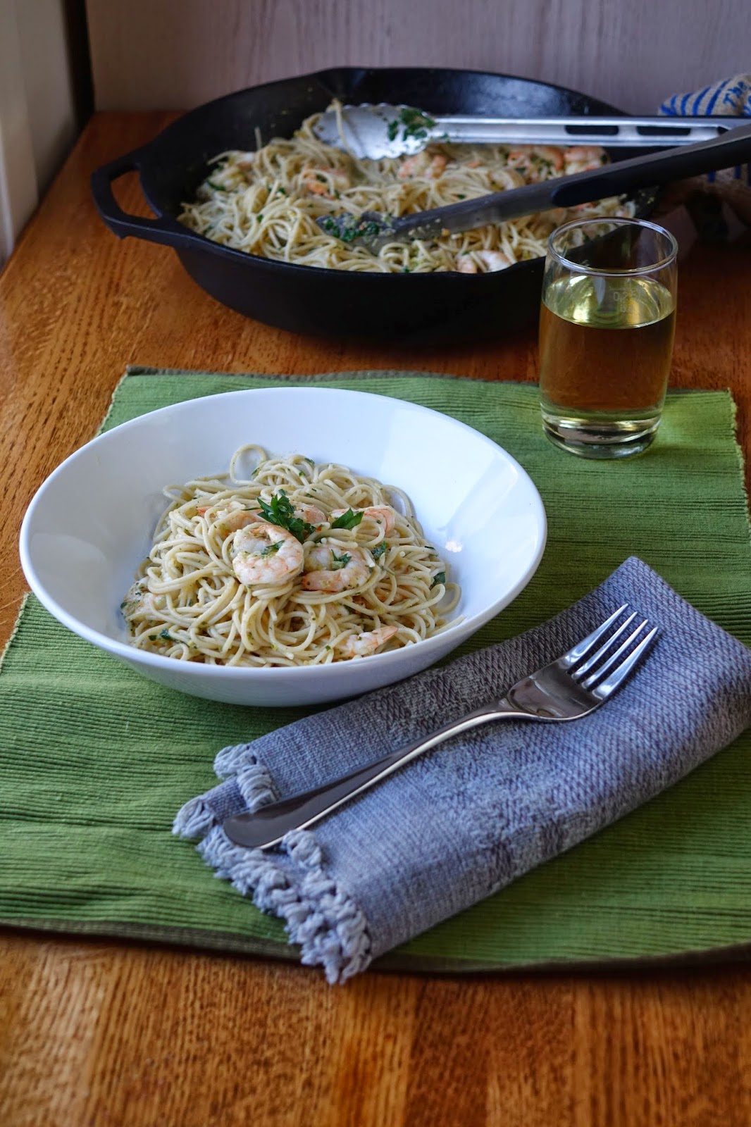 photo of shrimp, garlic scape pesto, and parsley in a wine/butter/lemon sauce over pasta.