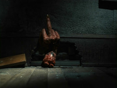 Ash's possessed hand sticking up the middle finger in Evil Dead II