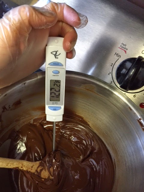 Measuring the temperature of chocolate in a bowl. Special infrared