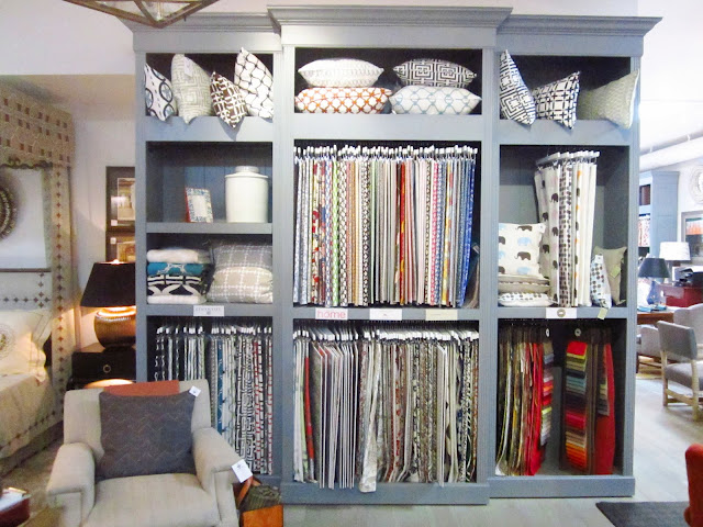 Textiles display with COCOCOZY fabrics, pillows and throws