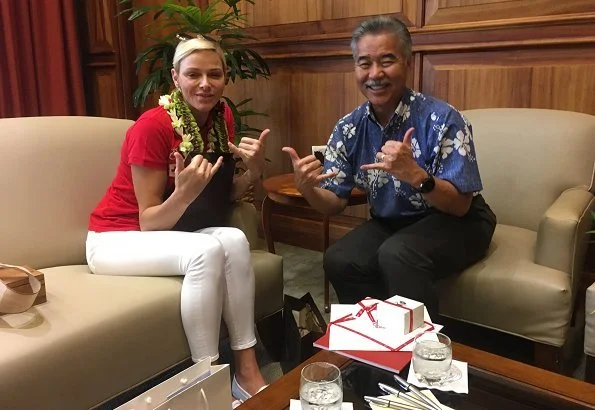 Princess Charlene of Monaco visited Honolulu, Hawaii met Governor David Idge. She wore red shirt and white pants