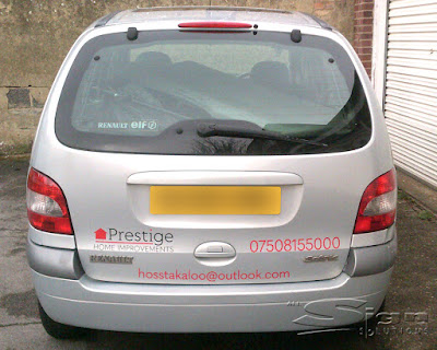 The back of Prestige Home improvements Renault car. The logo is featured, along with the phone number: 07508155000 and email address: hosstakaloo@outlook.com in a red colour with the silver car as the background.