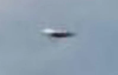 Flying Saucer Photographed Following A Military Plane