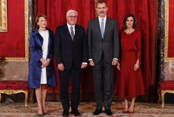 Queen Letizia wore Hugo Boss Vermana A-line wool and cashmere midi skirt and Hugo Boss Burana Silk Blouse