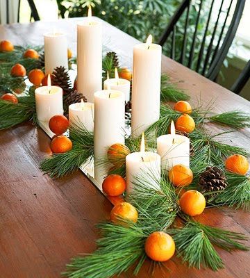 centro de mesa natal com velas e frutas