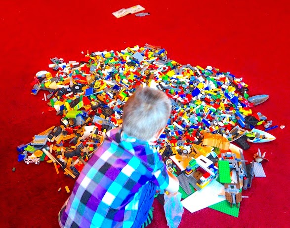 Morgan's Milieu | Why I love having the hardest job in the world (and you should too): A photo of LP playing in a pile of lego.