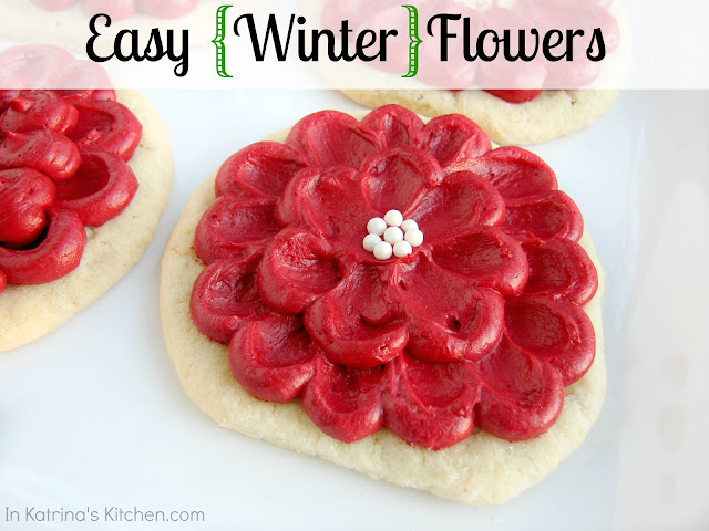 Easy Flower Cookies Circle sugar cookie with red frosting and white candies made to look like a flower