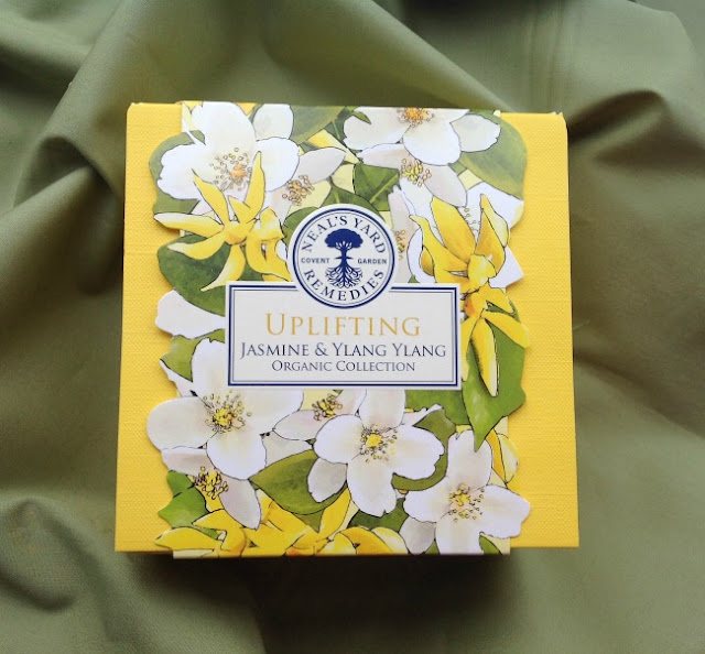 Picture of box, yellow with whit flowers on the sleeve. Uplifting Jasmine & Ylang Ylang.