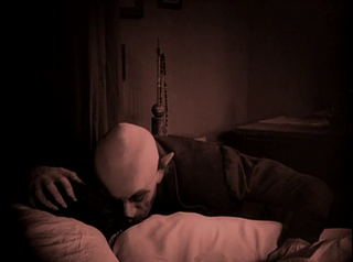 Max Schreck as Count Orlok feeds on Ellen Hunter (played by Greta Schröder), directed by F. W. Murnau