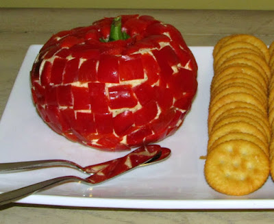cheese ball shaped like apple coated in red bell pepper