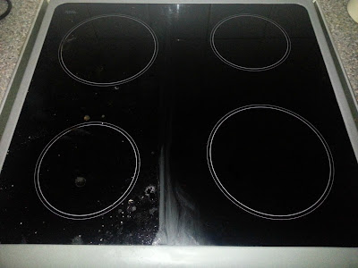 A hob top half cleaned with Eco Egg hard surface cleaner