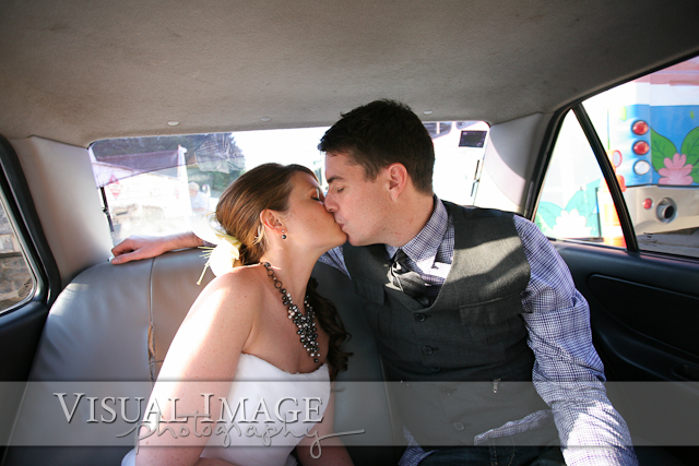 Bride and groom kissing in back of taxi in Playa del Carmen Mexico