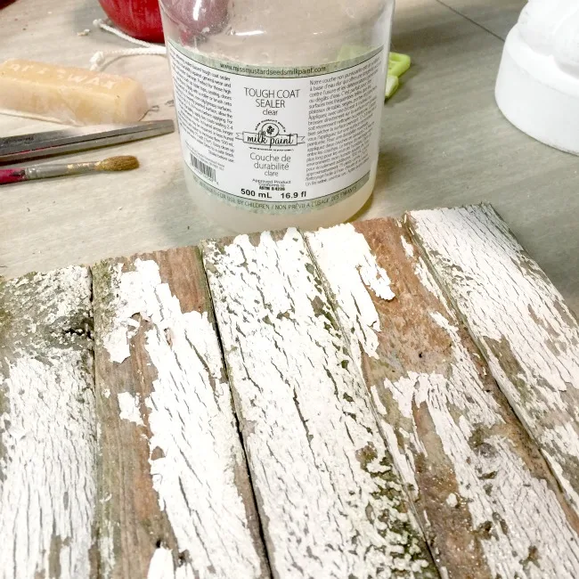 Chippy wood with bottle of Tough Coat Sealer