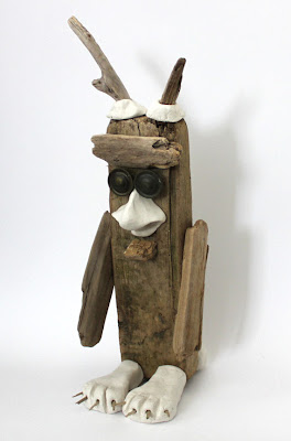 bird like monster sculpture made from clay and wood