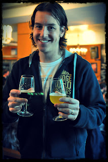 image of blogger with the doctors Orders Plasma White IPA and Mountain Goat/Mikkeller collaboration, Gypsy and the Goat Pepperberry Black IPA in each hand