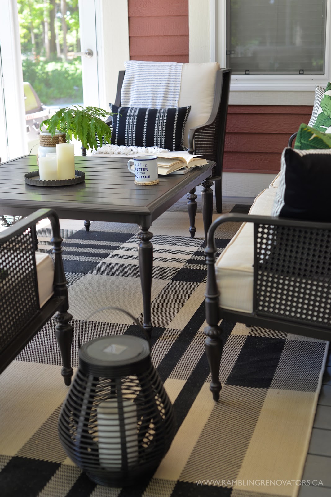 RamblingRenovators.ca | porch decor | outdoor caned wingback chair, plaid outdoor rug, palm leaves, cottage tropical decor