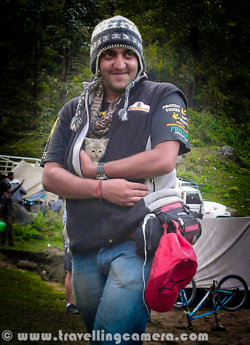 Apart from my heavy SLR Camera, I also carry a small Mobile phone by HTC which has a decent camera to shoot day pics anytime. All the photographs shared in this post are clicked by my Mobile Phone and I call it Mobilegiri :)The recent trip to Himachal Pradesh was quite exciting for different reasons. One of the reasons was meeting new friends during the journey. Here I am not talking about Parikshit. It's Billu, who is in his hands. A cute kitten. who met us on the way at Shawadh in kullu District.Everyone wanted to spend some time with this kitten. Aneesh is also trying to save her from chilly morning in Hills. He also took care of breakfast and all.After few minutes with Aneesh, she was quite comfortable and started climbing up. Here she is sitting on him shoulder. I love her expressions in this photograph, while covered in warm jacket.Here some another dear friend, Pradumn. We met him at Tani Jubber. He was here to visit his Grandparents, otherwise he stays in Shimla. His Grandmother is standing in the background and not sure if you noticed Apple orchard in the background. Anyway, there is hardly any clue to guess that it's an apple orchard :He was quite shy in the beginning and after few minutes of talk with Rohit (Khachi), he started dancing on 'Chhamakk Challo' form Ra-One :During this trip, we also crossed Shilaroo Hockey Stadium which is considered as highest Hockey ground in AsiaIt's located just roadside, surrounded by high peaks of Hatu on one side.Throughout the trip we stayed in tents but always tried to find a decent hotel for bath :) ... Although hot water was available at camps but adventurous bath-tents were not very convenient :) This was one of the hotel near Narkanda and Hatu.Here is a diversion for Hatu Peak from main road which connects Narkanda with Thanedar. Hatu peak is one of the popular place among Bollywood directors. Many movies are shot at this place.There were some talented bikers accompanying us. Specifically Aneesh, who drove me up till Hatu Peak and parked his bike here on top of a rock, which was not accessible through road. He drove his bike through different hills to reach this point.Here is a view of Hatu Temple from other side of the hill, which has amazing view to the valley in the foothills, dangerous as well. I am very scared when Aneesh was driving his bike on this hill and stopped just on edge.One of the view of Hills in Himachal on a cloudy day, which is most suitable for shooting any horror movie. Kali Ghanghor ghata types..One of the orchard house where we stayed for one night. It was in Tani Jubber and thanks to Pawan for all the arrangements at this place. Hot water was must thing during those days and it was like most precious thing for us.Here is another photograph from Orchard house in Tani Jubber, when we were moving ahead in the morning.Tani Jubber Lake in the morning...A photograph inside tent. The tripod in the front is used to place bulb and have proper light inside the tent. Folks inside the tent are Rohit, Pawan, Chandan, Parikshit and Saurabh (Left to Right). Thanks to Rohit, who made all our evenings joyful with his acts on various Himachali Policians :) - 'आले भाई, हेलिकोप्तल को लोका क्यों नहीं जब मैडम आ लाही थी तो :)'Colorful camping ground of Kullu Sarahan, where we spent a complete day and two nights. It was the best place to camp and experience Himalayan Nature.These are temporary toilets and bathrooms !!!A temporary bridge installed to connect camps with nearest road...Whole gang near Sarahan Waterfall. Almost everyone took bath in this chilling water !!!A quick photograph of Kullu Sarahan Village in Himachal Pradesh...It was breakfast time and we were sitting in Chalai fields to spot our targets for capturing in cameras. Rohit's curious look !!A quick Mobile click from a moving car, when a mother is doing the regular morning stuff !!Finally this trip ended at Ridge, Shimla... A person who walk between Sanjali and Mall Road, can very well describe this place. Lots of fruit shops near lakkar Bazar A typical Shimla hill with lots of highrise building on itThis is we used to take bath during these days. On some of the days, we located decent places and on other days such small waterfalls worked for us. Although water in these streams was chilling...