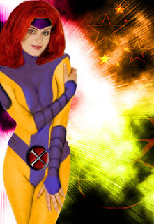 Redhead Jean Grey smiles in front of a rainbow colored background