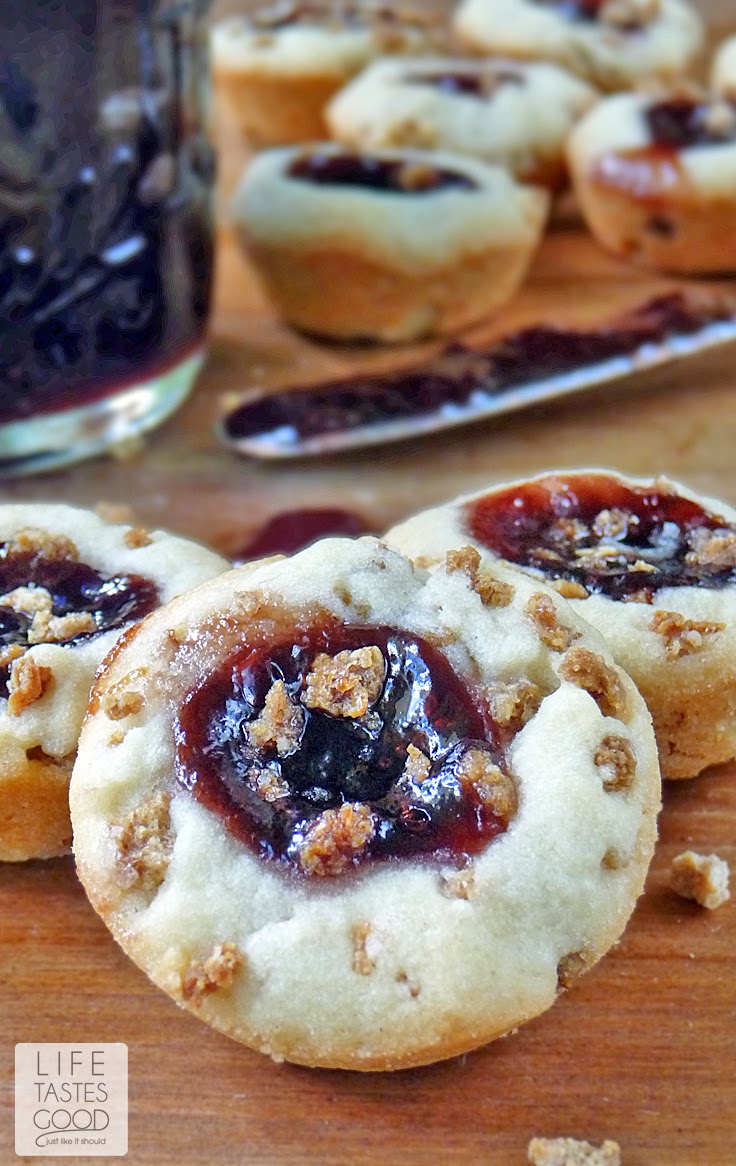 Jam Thumbprint Cookies | by Life Tastes Good are blissful little cookie bites. My jam thumbprint cookies are crunchy, and filled with any kind of jam you like best! They are a Christmas tradition in our house! Santa loves these cookies too!