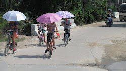 Girls, bikes, umbrellas.