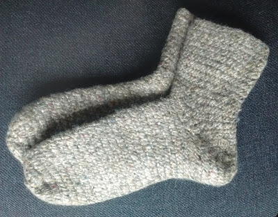 Thick brown woolen socks created by nalbinding