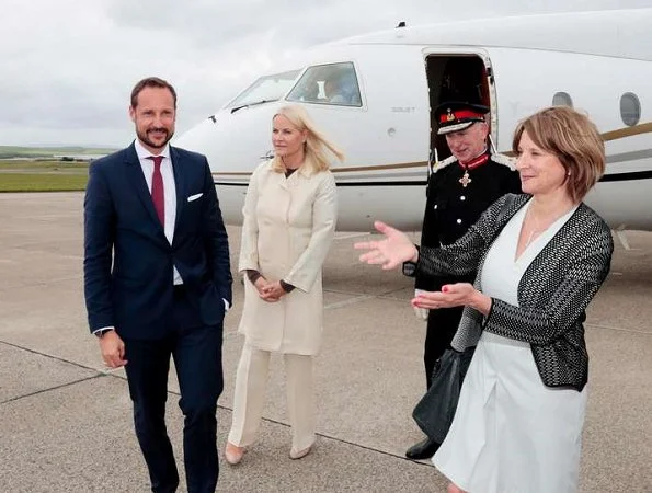 Crown Princess Mette-Marit and Crown Prince Haakon attended St. Magnus festival in Scotland. Prada dress, Christian Louboutin pumps