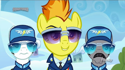Spitfire smiling, flanked by her staffers