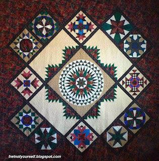 Original design of traditional quilt blocks in green, black, pink, blue, tan and white