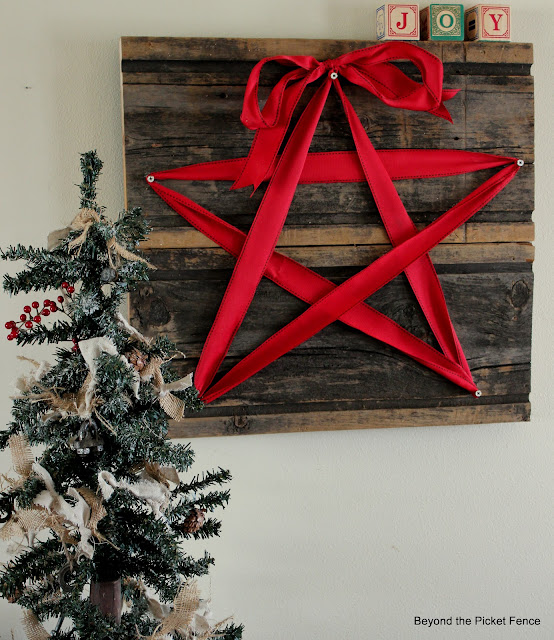 make a rustic and unique Christmas sign with some old barn wood and ribbon