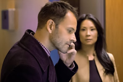 Jonny Lee Miller and Lucy Liu as Sherlock Holmes and Joan Watson in CBS Elementary Season 2 Episode 11 Internal Audit