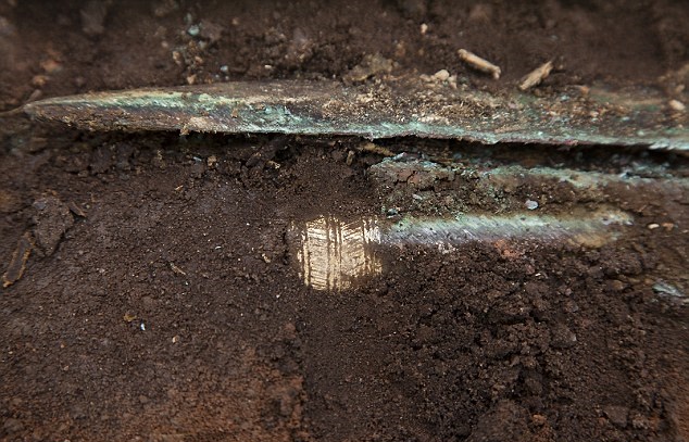 Archaeologists have uncovered what could be a gold-hilted Bronze Age sword dating back as far as 4,000 years on the site of a new community football pitch in Carnoustie, Angus, in Scotland [Credit: Paul Reid]Diggers moved into the site in Carnoustie, Angus, after a collection of artefacts were found while laying foundations for the new sports field.