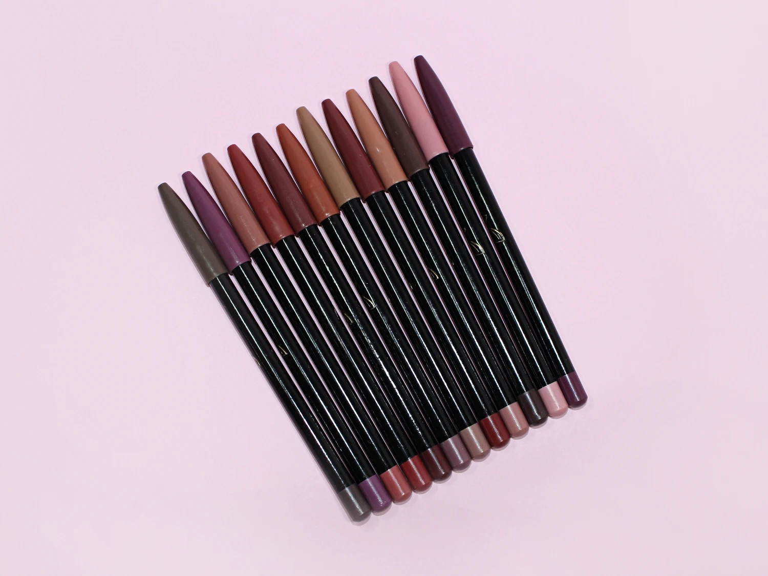 close-up studio picture of nude pencils on a plain rosy background