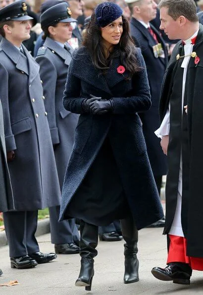 Meghan Markle wore Sentaler long wide collar wrap coat, Philip Treacy hat, Tamara Mellon boots. Royal British Legion traditional paper poppy