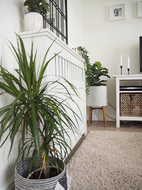 How to style a radiator cover in your living room using accessories and items you already own including artificial greenery, candles and flowers.