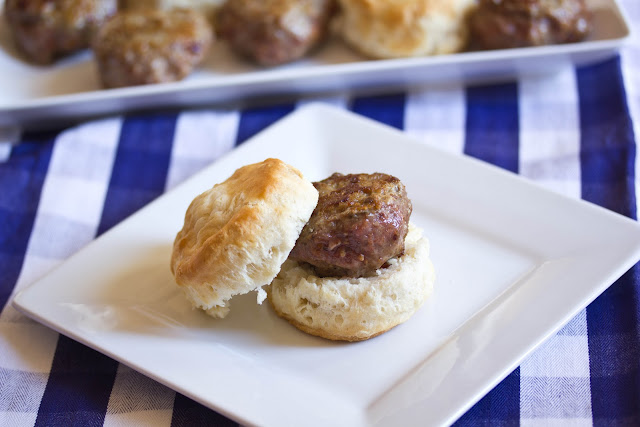 turkey sausage sitting on a biscuit on a white plate