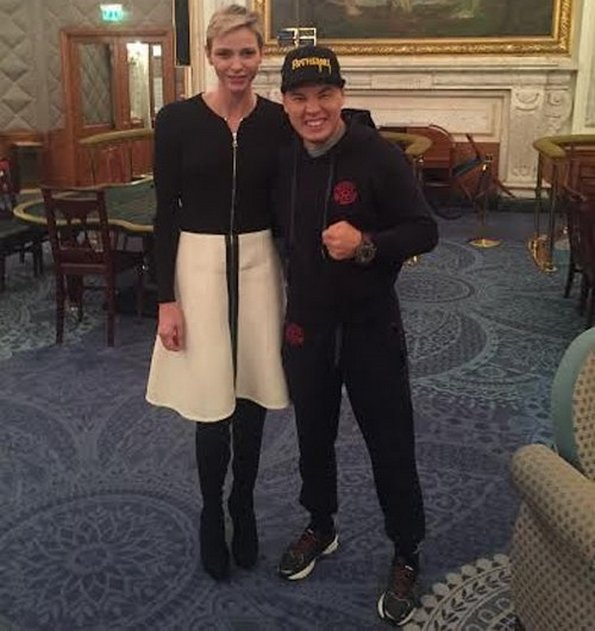 Princess Charlene of Monaco posing with one of the boxers who will take part in tomorrow's tournament in Monaco. 