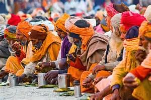hindu pilgrims eating holy prasad - kumbh mela 2013