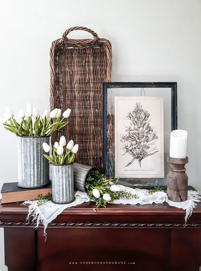 Spring mantel decorated with tulips and vintage finds
