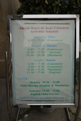 sign showing schedule of church services and events with only a few being in English