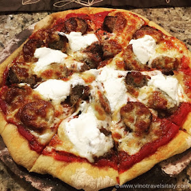 Making a meatball pizza with ricotta and mozzarella
