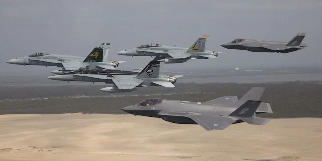 Image Attribute: Royal Australian Air Force F/A-18 Hornets fly in formation with a pair of F-35A Joint Strike Fighters over Stockton Beach, NSW. (Before landing at Williamtown AFB) / Source: Australian Defence Force