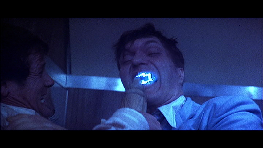 The-Spy-Who-Loved-Me-James-Bond-Roger-Moore-Jaws-Richard-Kiel-mouth-electricity.png