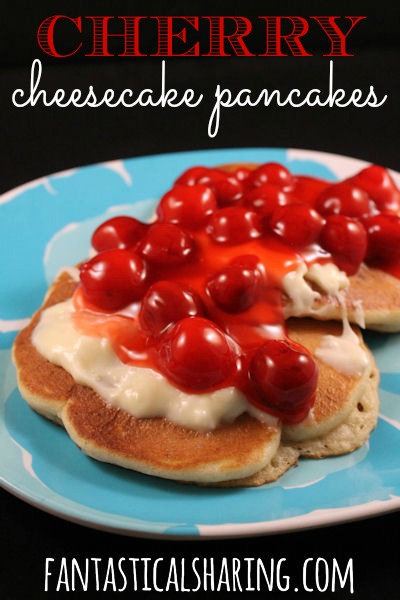Cherry Cheesecake Pancakes | Fluffy pancakes w/pieces of cheesecake inside topped w/a cream cheese frosting & more than one cherry on top!